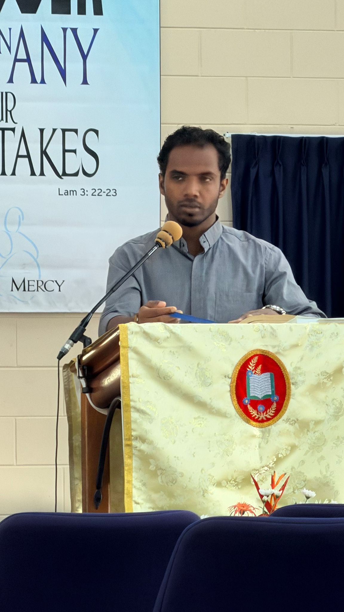 Felix speaking at a church lectern